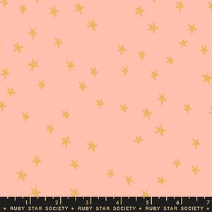May include: Pink fabric with a repeating pattern of gold stars. The stars are irregularly shaped and scattered across the surface. The fabric has a soft, matte finish. The text "RUBY STAR SOCIETY" is printed at the bottom.