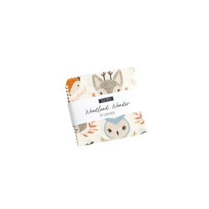 May include: A fabric square with a woodland theme featuring a fox, owl, and other forest animals. The fabric is white with brown, orange, and blue accents. The text "Woodland Wonder by Gingiber" is printed on the fabric.