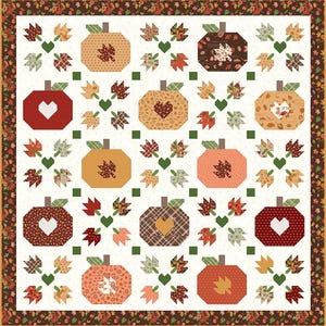 May include: A square quilt featuring a repeating pattern of pumpkins and autumn leaves in shades of orange, red, brown, and green. The design includes heart-shaped cutouts on some pumpkins and a dark brown border with a floral and leaf print.