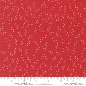 May include: Red fabric with a repeating pattern of small, white bird footprints. The fabric has a ruler along the bottom edge, marked in inches. The fabric is likely cotton or a similar material, suitable for quilting or crafting projects.