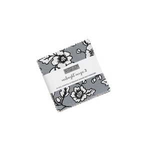 May include: A pack of fabric squares with a floral pattern in black and white on a light blue background. The pack is labeled "midnight magic 2 by April Rosenthal of Prairie Grass Patterns".