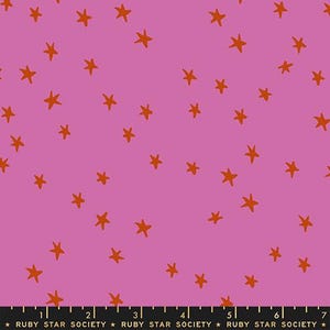May include: A fabric with a pink background and scattered orange stars. The stars are hand-drawn in a simple, irregular style. The bottom of the fabric has text that reads "RUBY STAR SOCIETY".