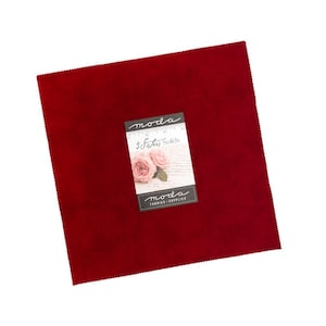 May include: A square piece of deep red fabric with pinked edges. A white label is centered on the fabric, featuring the text "moda", "3 Sisters Solids", and "moda FABRICS + SUPPLIES" along with an image of two pink roses and a ruler marking 4 inches.