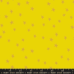 May include: Yellow fabric with a scattered pattern of tan stars. The stars are irregularly shaped and appear hand-drawn. The fabric has a bright, cheerful appearance, suitable for various craft projects.