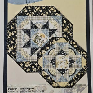 May include: A sewing pattern titled Rosie O' Doiley by Sonja Lea Designs featuring two octagon table toppers in black, blue, and cream floral and plaid fabrics. The text indicates a medium size of 28 inches by 28 inches and a small size of 20 inches by 20 inches.