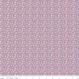 May include: A fabric with a repeating pattern of small, colorful circles and white leaf-like shapes on a lavender background. The circles are in shades of red, blue, yellow, and green. The fabric is likely cotton or a similar material.