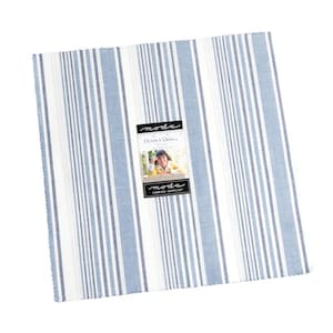 May include: A stack of fabric squares with a blue and white striped pattern. The fabric squares have a label that reads "Moda Fabrics & Supplies". The fabric squares are likely for quilting or other sewing projects.