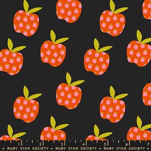 May include: A repeating pattern of stylized apples on a black background. The apples are orange with pink apple-shaped details and green leaves. The text "RUBY STAR SOCIETY" is at the bottom.