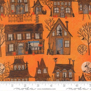 May include: A vibrant orange fabric featuring a repeating pattern of brown houses, bare trees, black cats, witches, and pumpkins. A white ruler at the bottom shows measurements in inches, with the text "moda" and "www.modafabrics.com" printed.