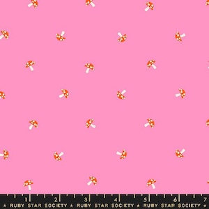 May include: Pink fabric with a repeating pattern of small orange mushrooms with white polka dots and white stems. The fabric has the text "RUBY STAR SOCIETY" at the bottom.