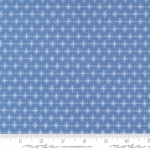 May include: A blue fabric featuring a repeating pattern of small white starbursts and dots arranged in horizontal rows. A white measuring tape is visible at the bottom edge, showing markings from 1 to 7 inches along the fabric's lower border.