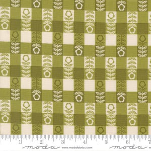 May include: Green and cream-colored fabric with a checkered pattern. The design features vertical rows of stylized white flowers and leaves on a green background. The fabric has a vintage, floral aesthetic, suitable for quilting or crafting projects.