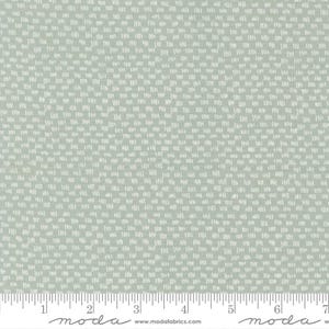 May include: A light green fabric with a repeating pattern of small, white, dashed lines arranged in a grid. The fabric has a subtle texture and a soft, muted color palette. The fabric is suitable for quilting and other craft projects.
