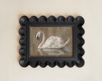 May include: A framed painting of a white swan on water. The swan is depicted with soft brushstrokes, set against a muted brown background. The black frame has a wavy, scalloped edge, adding a decorative touch to the artwork.