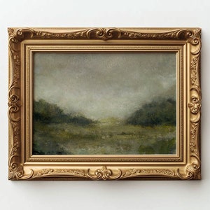 A gold ornate frame holds a vintage landscape oil painting on a white wall.