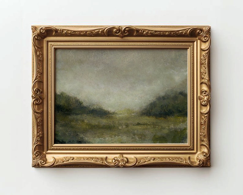 A gold ornate frame holds a vintage landscape oil painting on a white wall.
