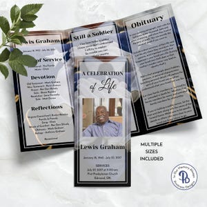 May include: A black and white funeral program with a photo of a man in a blue shirt. The program includes the name Lewis Graham, dates of birth and death, and the text "Still a Soldier" and "A Celebration of Life".