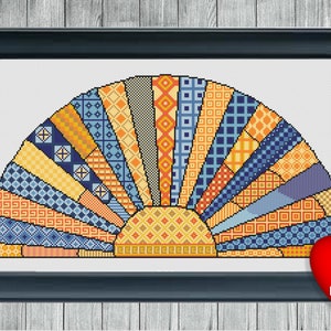 May include: A colorful geometric pattern in shades of blue, orange, and yellow forms a stylized sunburst design. The pattern is reminiscent of a quilt or patchwork.