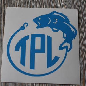 May include: A blue vinyl decal with a fish jumping out of the water and a circle with the letters "TPL" inside.