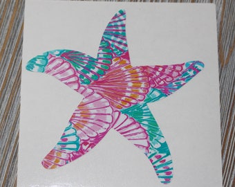 May include: A pink, teal and orange starfish sticker with a seashell pattern.