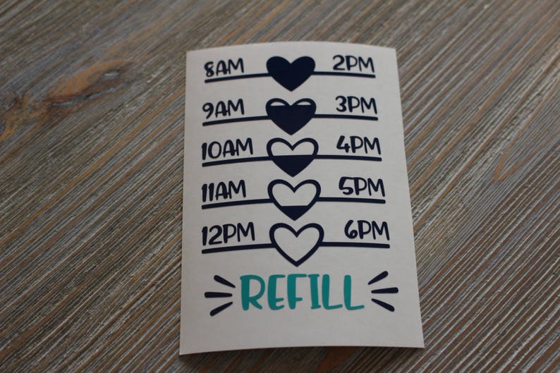 May include: A white sticker with black text and blue hearts. The sticker has a time schedule from 8 AM to 6 PM with a refill reminder at the bottom.