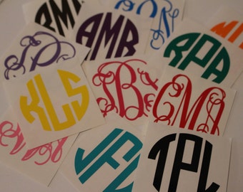 May include: Assortment of colorful monogram stickers with various letter combinations. The stickers are on white square backgrounds.