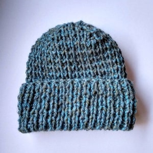 May include: A blue and green knitted beanie hat with a ribbed texture.