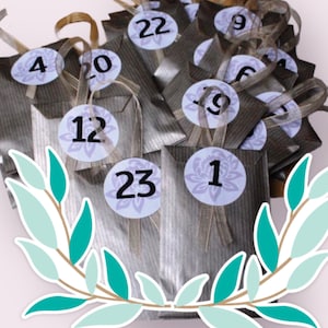 May include: An advent calendar featuring silver paper bags, each with a numbered sticker from 1 to 23. The stickers have a floral design and are attached with ribbons. The bags are arranged in a bundle.