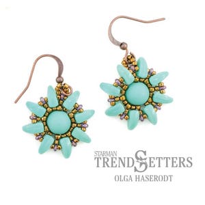 May include: A pair of turquoise and gold beaded earrings with a Starman Trendsetters Olga Haserodt logo.