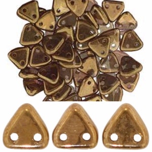 May include: A pile of gold-colored triangle-shaped beads with two holes each. Three individual beads are shown below the pile.