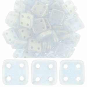 May include: A pile of white ceramic square tiles with four holes in each tile. The tiles are arranged in a random pattern. Three individual tiles are shown below the pile.