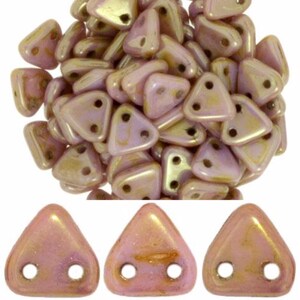 May include: A group of small, iridescent pink triangle beads with two holes each. The beads have a subtle shimmer and are perfect for jewelry making.