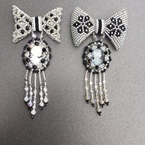 May include: Two black and white beaded bow brooches with a cameo pendant and crystal fringe.