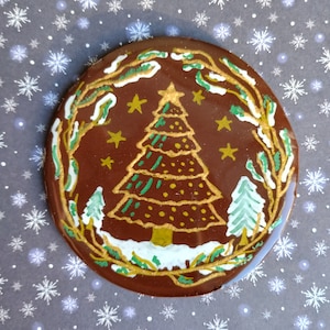 Dessous de verre fait main avec un motif de Noël en pâte polymère