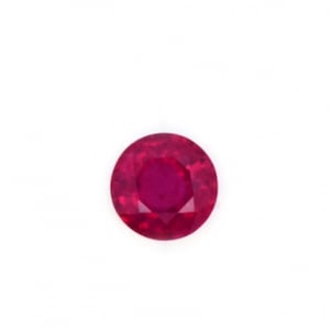 May include: A round, faceted ruby gemstone. The gem is a deep, vibrant red color and is set against a plain white background. The ruby's facets catch the light, creating a sparkling effect. This image showcases the beauty of a precious gemstone.