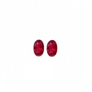 May include: Two oval-cut loose gemstones with a deep, vibrant red color. These faceted stones feature a polished surface that reflects light, showcasing a clear, transparent quality and a symmetrical shape, presented as a pair of matching red gems.