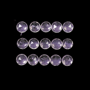 May include: A collection of 15 faceted rose quartz gemstones, each with a unique, irregular shape. The stones are arranged in three rows of five, and they are all a pale pink color.
