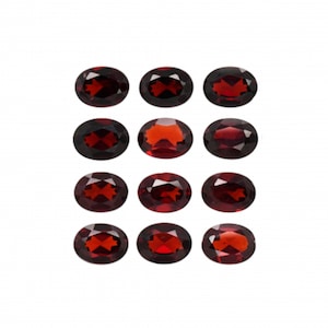 Może przedstawiać: Dwunastu owalnych, czerwonych kamieni szlachetnych. Kamienie szlachetne są ułożone w trzech rzędach po cztery.