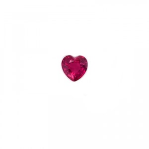 May include: A heart-shaped, faceted gemstone in a vibrant shade of red. The gemstone is set against a plain white background, highlighting its shape and colour. The gem's facets catch the light, creating a sparkling effect.