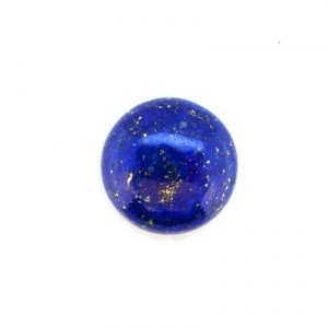 May include: A round, polished lapis lazuli gemstone. The deep blue stone is speckled with flecks of gold pyrite, creating a striking contrast. The gemstone is set against a plain white background, highlighting its color and texture.