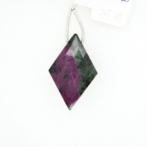 May include: A green and purple gemstone pendant in a diamond shape.