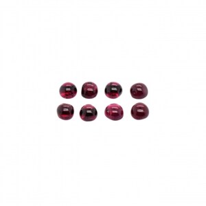 May include: Eight round, red gemstones. The gemstones are smooth and polished.