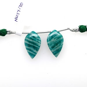 May include: Two green and white striped amazonite gemstone beads in a pear shape. The beads are strung on a silver wire with a green tassel on each end. The beads are labeled "NW17-70".