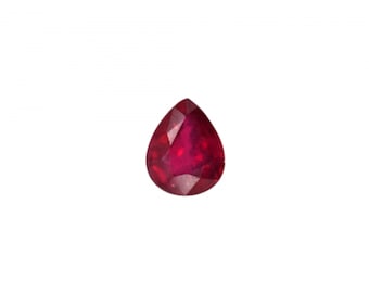 May include: A pear-shaped ruby gemstone with a deep red color.