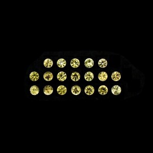 Op de afbeelding: Een verzameling van 18 ronde, gefacetteerde, gele edelstenen, gepresenteerd in een zwarte lade.