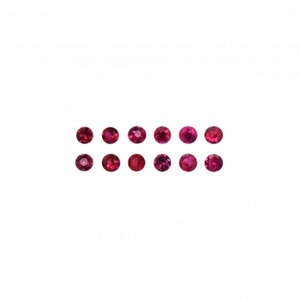 May include: A collection of 14 round, red gemstones. The gemstones are arranged in two rows of seven.