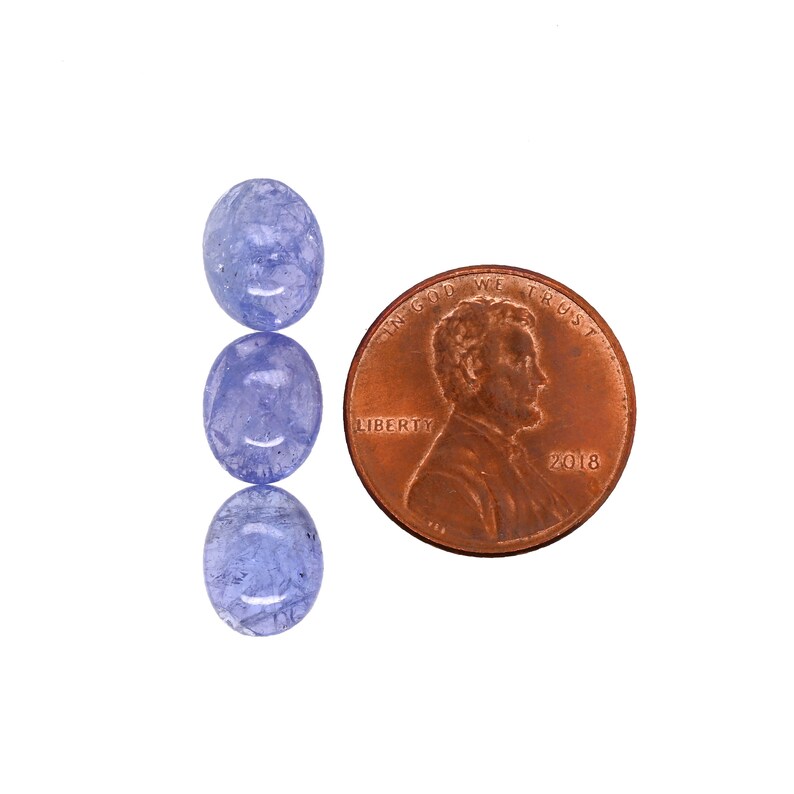 May include: Three oval-shaped blue gemstones, each about the size of a penny. The gemstones are translucent and have a light blue color.