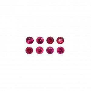 May include: Eight round, faceted, deep pinkish-red gemstones arranged in two horizontal rows of four. Each stone features a brilliant cut with multiple facets that reflect light, creating a sparkling appearance against a plain white background.