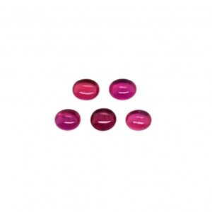 May include: Five round, pink gemstones with a smooth, polished finish.