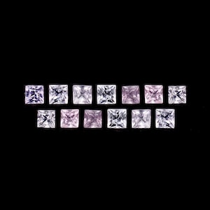 May include: A row of 12 square-shaped gemstones, ranging in color from clear to light pink. The gemstones are arranged in a gradient pattern, with the clearest stones on the left and the pinkest stones on the right.